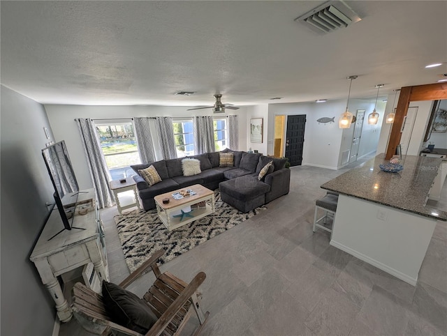 3713 N Suwanee Pt, Crystal River, FL 34428 - living area featuring visible vents, baseboards, a textured ceiling, and a ceiling fan