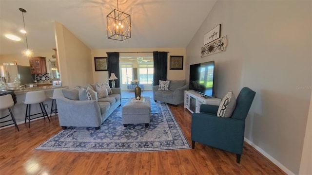 5291 NW 20th Pl, Ocala, FL 34482 - living area with baseboards, high vaulted ceiling, an inviting chandelier, and wood finished floors