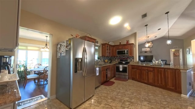 5291 NW 20th Pl, Ocala, FL 34482 - kitchen with visible vents, stainless steel appliances, decorative backsplash, vaulted ceiling, and pendant lighting
