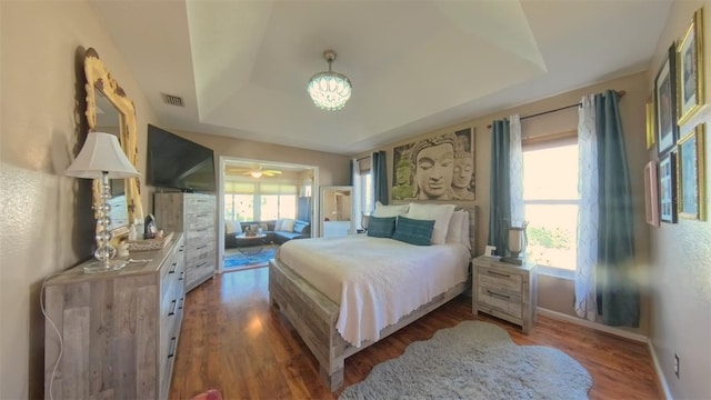 5291 NW 20th Pl, Ocala, FL 34482 - bedroom featuring visible vents, a raised ceiling, baseboards, and wood finished floors