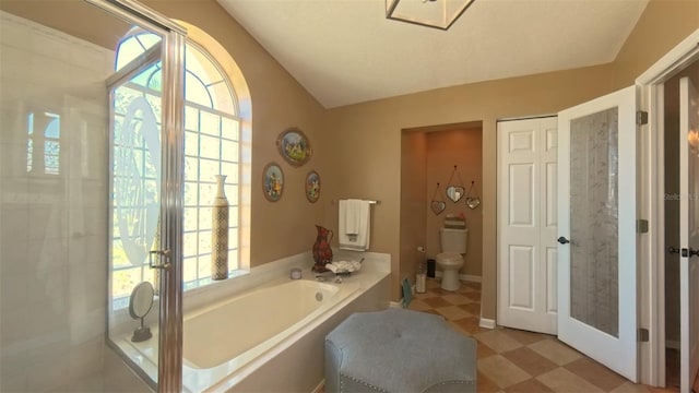 5291 NW 20th Pl, Ocala, FL 34482 - bathroom featuring a wealth of natural light, toilet, a bath, and tile patterned floors