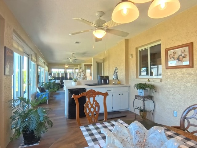 5291 NW 20th Pl, Ocala, FL 34482 - dining space with a ceiling fan, a textured wall, and dark wood-style flooring