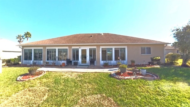 5291 NW 20th Pl, Ocala, FL 34482 - rear view of house featuring a yard, a patio area, stucco siding, and french doors