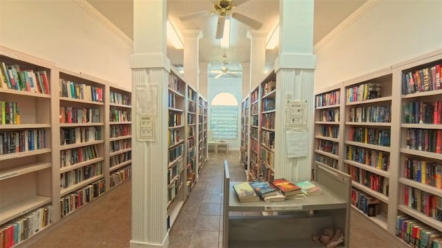 5291 NW 20th Pl, Ocala, FL 34482 - living area featuring tile patterned floors, crown molding, a ceiling fan, and bookshelves
