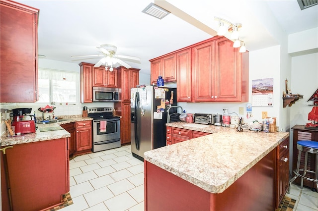 390 SW Shorewood Dr, Dunnellon, FL 34431 - kitchen featuring visible vents, ceiling fan, a peninsula, and stainless steel appliances