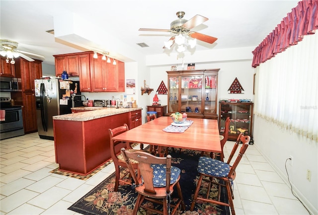 390 SW Shorewood Dr, Dunnellon, FL 34431 - dining area with light tile patterned floors, ceiling fan, and visible vents