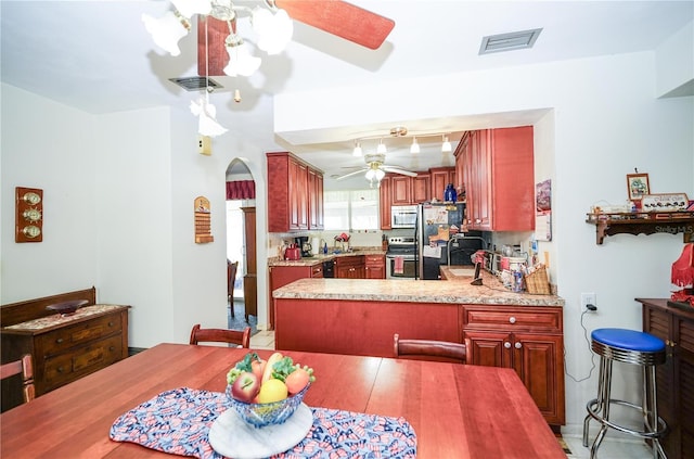390 SW Shorewood Dr, Dunnellon, FL 34431 - dining room featuring a ceiling fan, visible vents, and arched walkways
