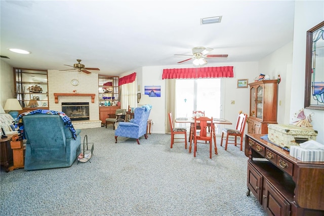 390 SW Shorewood Dr, Dunnellon, FL 34431 - carpeted living area with a fireplace, ceiling fan, and visible vents