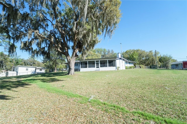 390 SW Shorewood Dr, Dunnellon, FL 34431 - exterior space with a sunroom, a front lawn, and fence