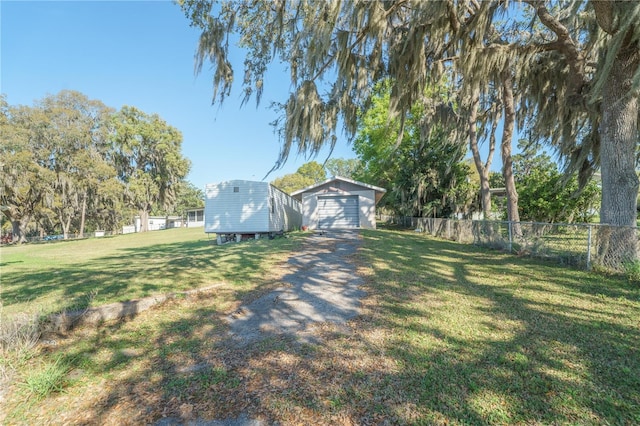 390 SW Shorewood Dr, Dunnellon, FL 34431 - view of yard featuring fence, an outdoor structure, and a garage