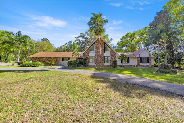 2130 SW 37th Street Rd, Ocala, FL 34471 - view of front of house featuring aphalt driveway, stone siding, and a front yard