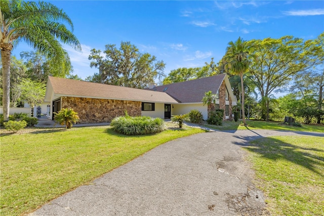 2130 SW 37th Street Rd, Ocala, FL 34471 - view of front of house featuring a front yard, stone siding, driveway, and stucco siding
