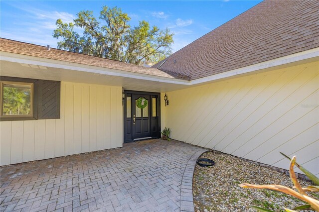 2130 SW 37th Street Rd, Ocala, FL 34471 - doorway to property with roof with shingles and a patio area