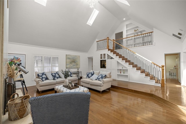 2130 SW 37th Street Rd, Ocala, FL 34471 - living area featuring built in shelves, wood finished floors, a skylight, and stairs