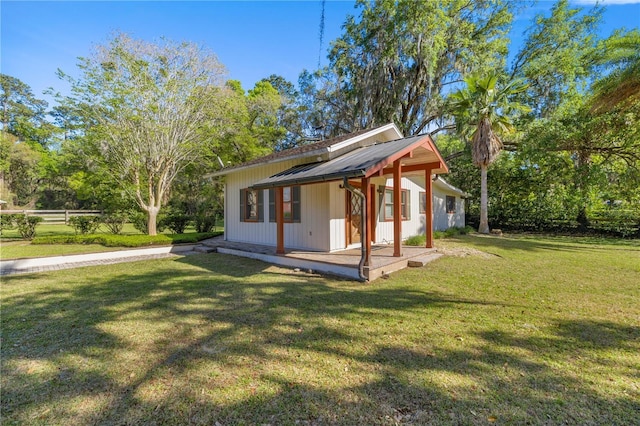 2130 SW 37th Street Rd, Ocala, FL 34471 - back of property with a yard, metal roof, and an outdoor structure