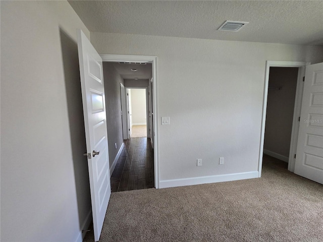 5045 N Triple Eagle Path, Beverly Hills, FL 34465 - empty room with dark colored carpet and a textured ceiling