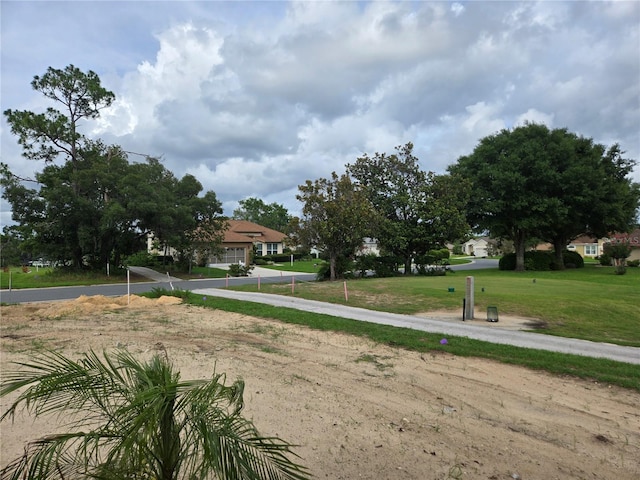 310 W Rexford Dr, Beverly Hills, FL 34465 - view of green lawn featuring driveway