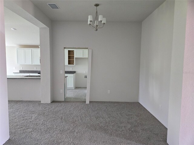310 W Rexford Dr, Beverly Hills, FL 34465 - unfurnished room featuring a chandelier and light carpet
