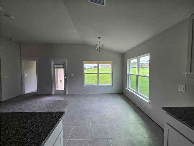 310 W Rexford Dr, Beverly Hills, FL 34465 - unfurnished dining area with plenty of natural light, lofted ceiling, a chandelier, and light tile patterned floors