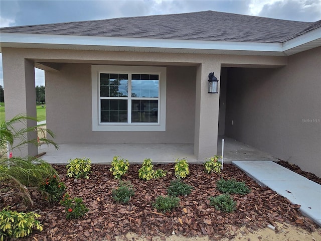 310 W Rexford Dr, Beverly Hills, FL 34465 - doorway to property with a shingled roof and stucco siding