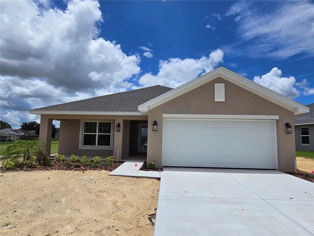 310 W Rexford Dr, Beverly Hills, FL 34465 - ranch-style house featuring stucco siding, concrete driveway, an attached garage, and a shingled roof