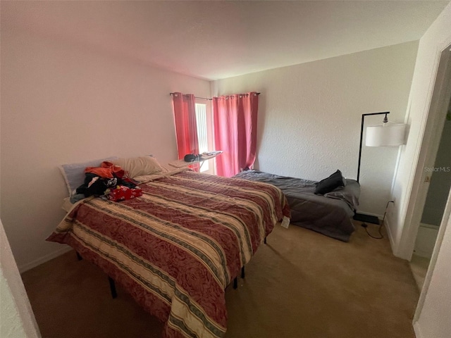 bedroom featuring baseboards and carpet floors