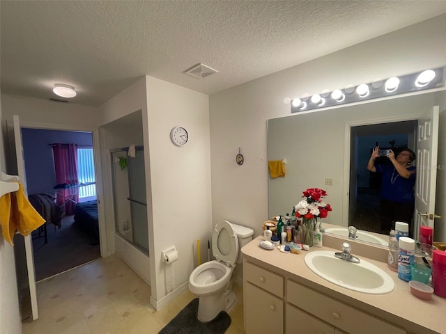 full bathroom featuring vanity, visible vents, a textured ceiling, tile patterned floors, and toilet