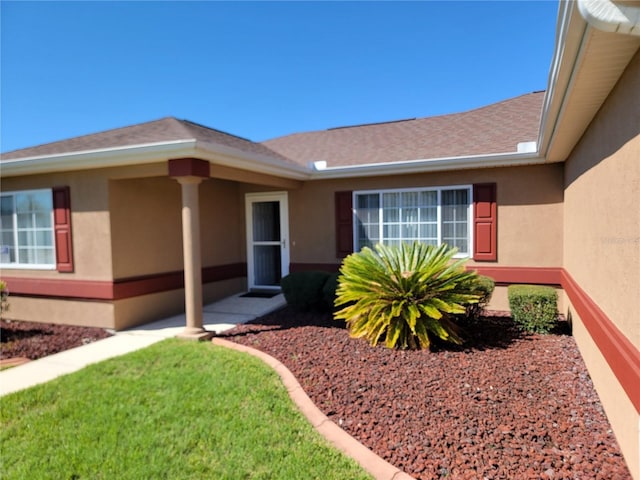 11395 SW 139th St, Dunnellon, FL 34432 - view of exterior entry with stucco siding and a shingled roof