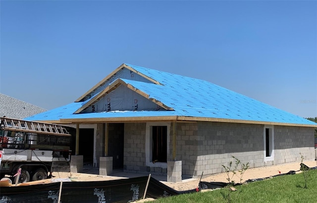 property in mid-construction featuring concrete block siding