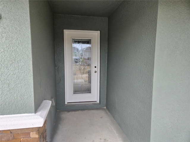 253 W Twisted Oaks Dr, Beverly Hills, FL 34465 - doorway to property featuring stucco siding