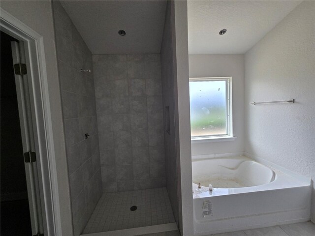 253 W Twisted Oaks Dr, Beverly Hills, FL 34465 - bathroom featuring a garden tub, tiled shower, and tile patterned floors