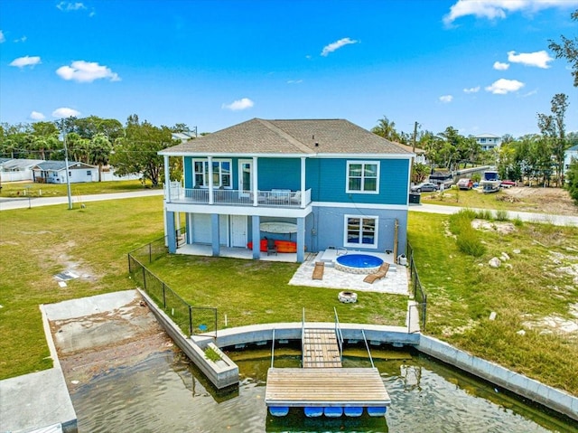rear view of house featuring a balcony, a fenced backyard, a patio area, a lawn, and a water view