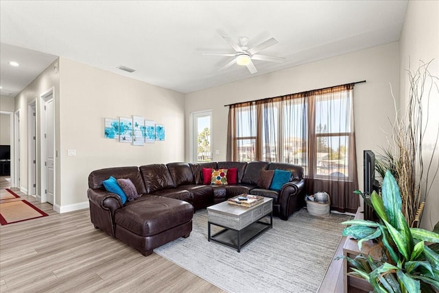 living room featuring ceiling fan, visible vents, baseboards, light wood finished floors, and recessed lighting