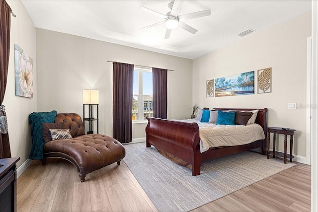 bedroom with baseboards, light wood-style flooring, and visible vents