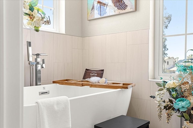 bathroom with a soaking tub