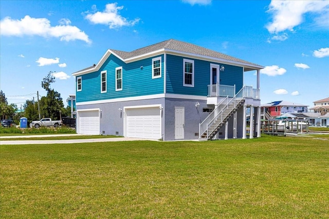 view of front of property with concrete driveway, an attached garage, stairway, and a front lawn