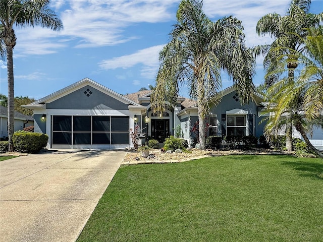 single story home with a garage, a front yard, driveway, and stucco siding