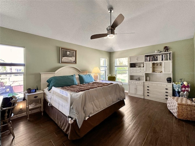 bedroom with dark wood-style floors, baseboards, ceiling fan, and a textured ceiling