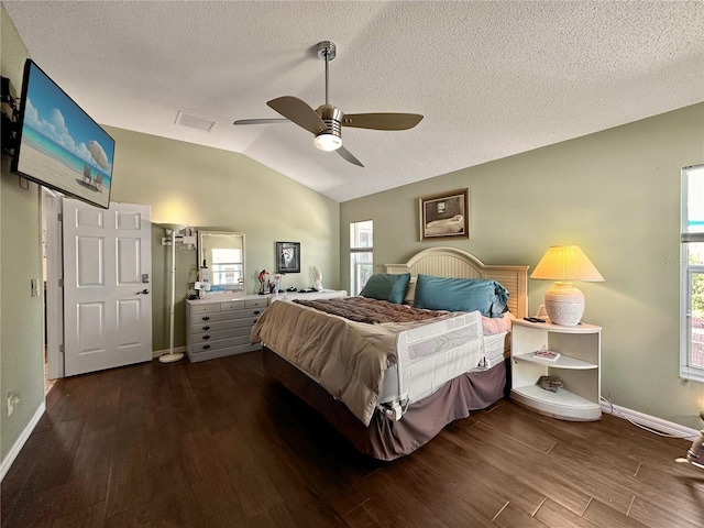 bedroom with baseboards, vaulted ceiling, dark wood-type flooring, and a textured ceiling