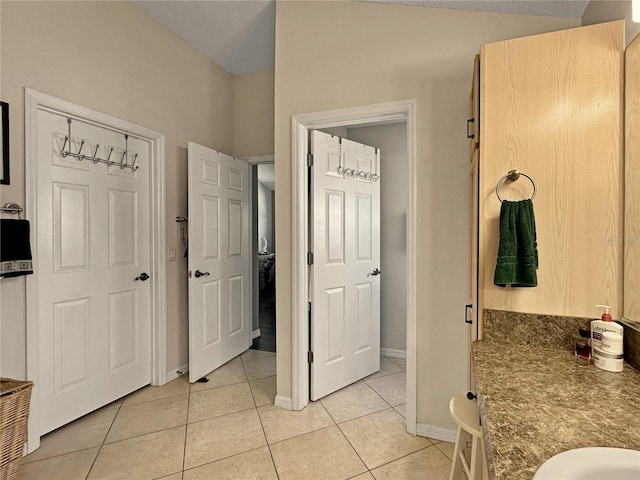 bathroom with tile patterned floors and baseboards