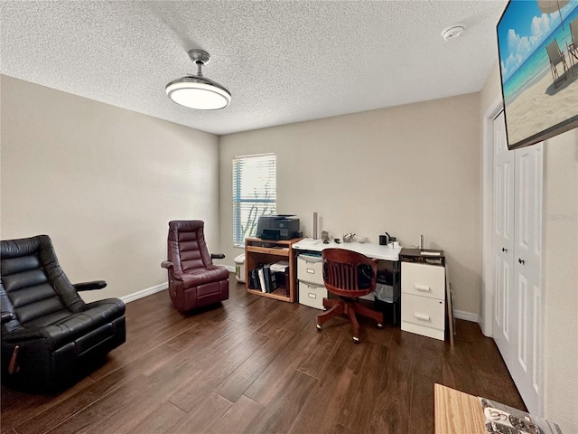 office with dark wood-style floors, baseboards, and a textured ceiling