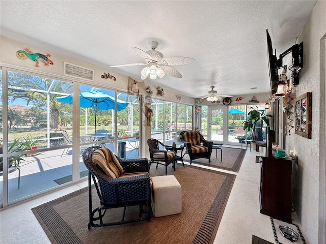 sunroom featuring a ceiling fan
