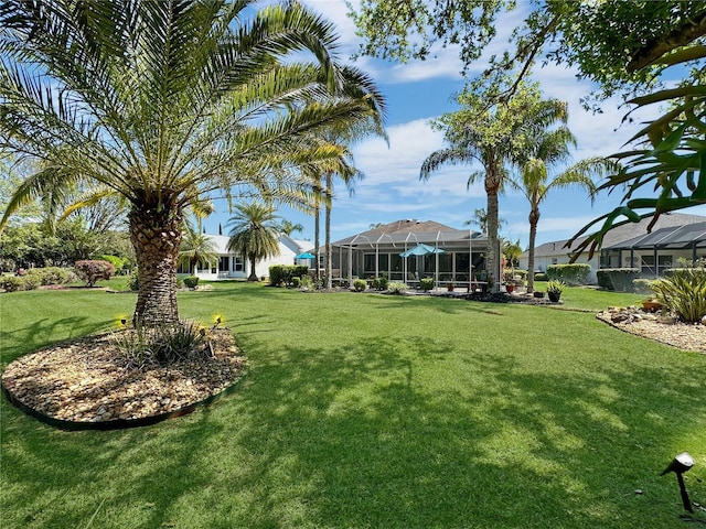 view of yard with glass enclosure