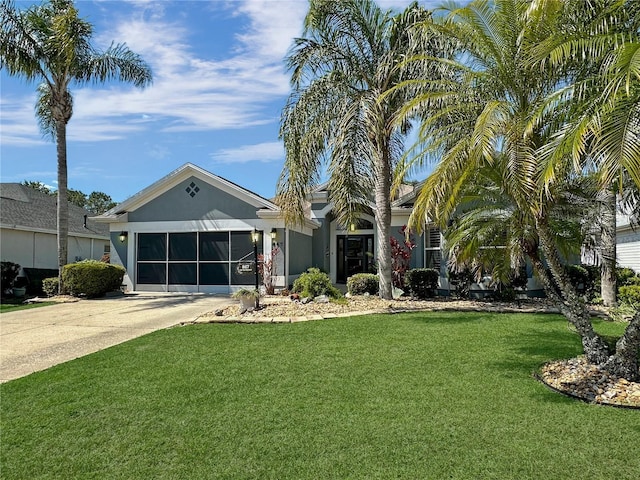 view of front of house featuring stucco siding, concrete driveway, a front lawn, and an attached garage