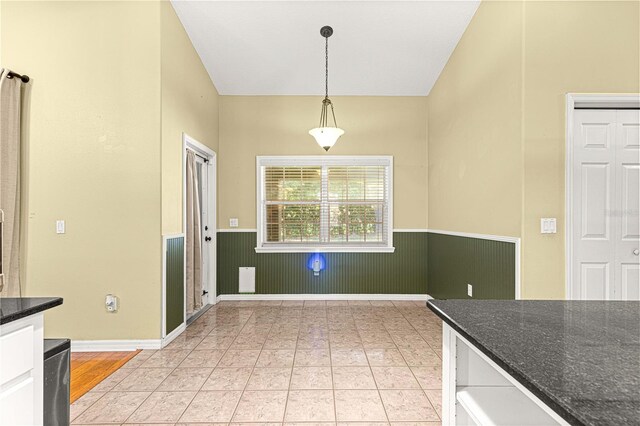 2922 SE 39th Pl, Ocala, FL 34480 - kitchen featuring white cabinetry, decorative light fixtures, dark stone countertops, and wainscoting