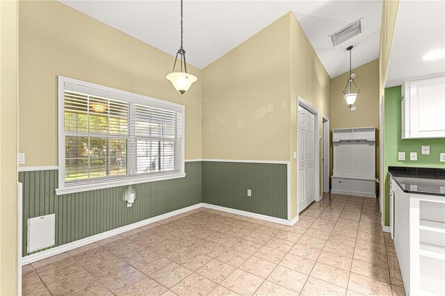 2922 SE 39th Pl, Ocala, FL 34480 - kitchen featuring white cabinets, visible vents, vaulted ceiling, and wainscoting