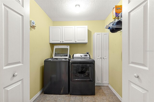 2922 SE 39th Pl, Ocala, FL 34480 - clothes washing area with baseboards, cabinet space, a textured ceiling, and separate washer and dryer