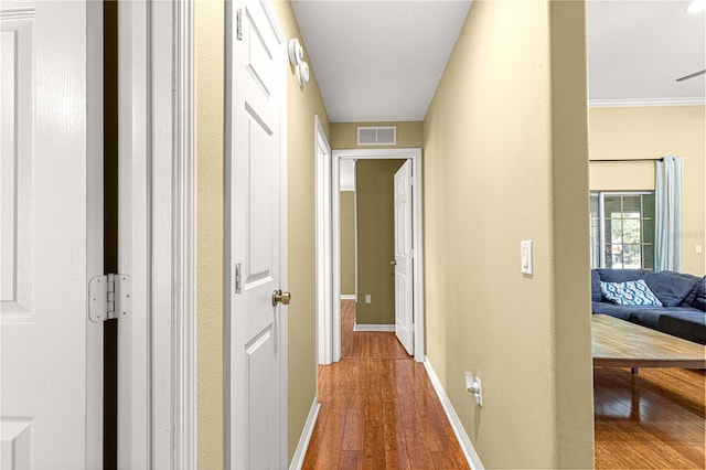 2922 SE 39th Pl, Ocala, FL 34480 - hallway featuring baseboards, visible vents, and wood finished floors