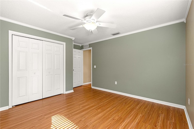 2922 SE 39th Pl, Ocala, FL 34480 - unfurnished bedroom featuring light wood-type flooring, crown molding, visible vents, and a closet