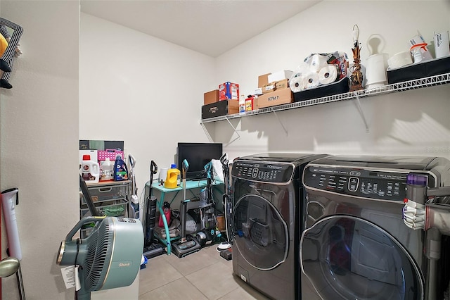 washroom featuring independent washer and dryer, tile patterned flooring, and laundry area